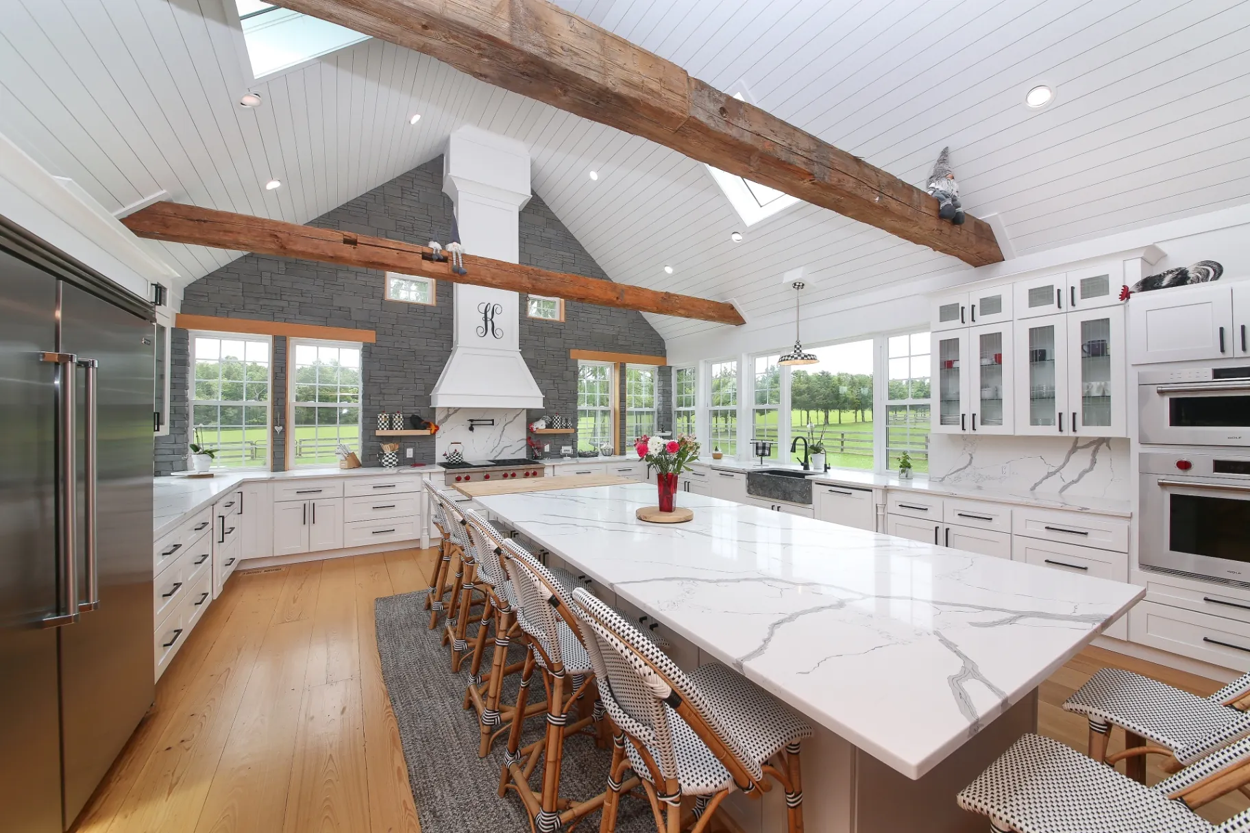 Custom Bucks County kitchen remodel with vaulted shiplap ceiling, reclaimed beams and Calacatta quartz island