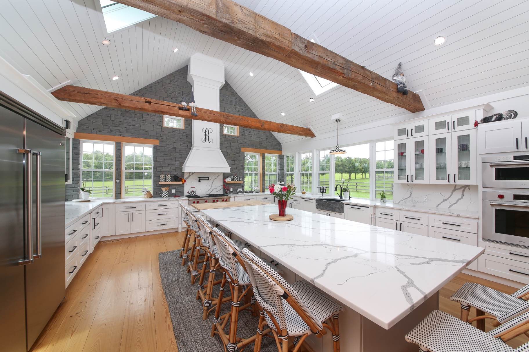 Custom Bucks County kitchen remodel with vaulted shiplap ceiling, reclaimed beams and Calacatta quartz island